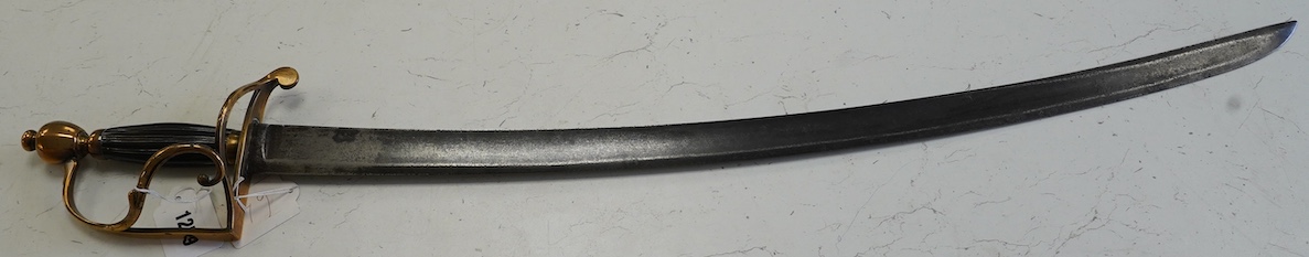 An English officer’s hanger, c.1800. brass grip with scrolling side bar, fluted ebony grip, blade 74.5cm. Condition - fair, guard significantly altered
